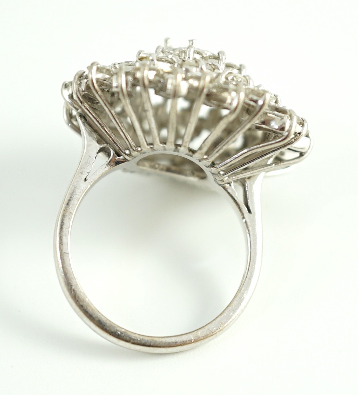 A modern 18ct white gold, ruby and round, baguette and marquise cut diamond cluster set dress ring